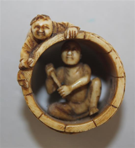 A Japanese ivory netsuke of two men constructing a barrel, Meiji period, 2.8cm